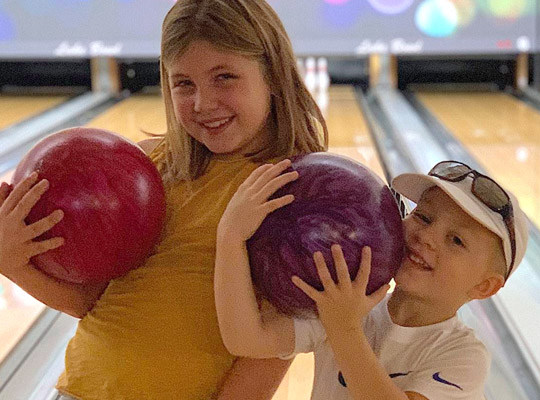 2 kids at a bowling alley birthday party